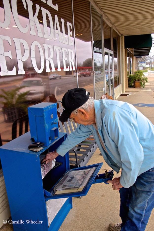 Eugene Lane, an 82-year-old Rockdale resident who has been reading The Rockdale Reporter for 40 years, grabs a newspaper hot off the press.